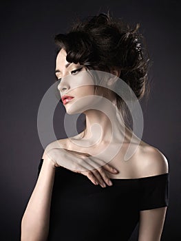 Beautiful woman with elegant hairstyle on black background