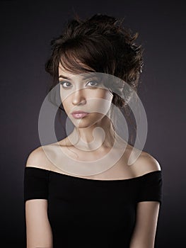 Beautiful woman with elegant hairstyle on black background