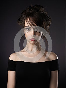 Beautiful woman with elegant hairstyle on black background