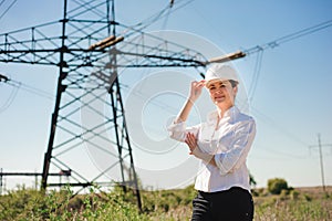 Beautiful woman engineer work at an electrical substation.