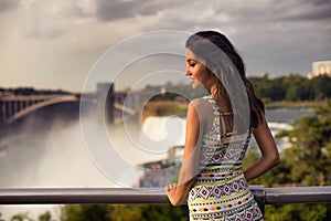 Beautiful woman enjoing the view of Niagara Fall photo