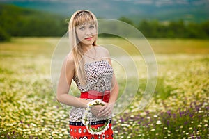 Beautiful woman enjoying daisy field, nice female lying down in meadow of flowers, pretty girl relaxing outdoor, having fun, holdi