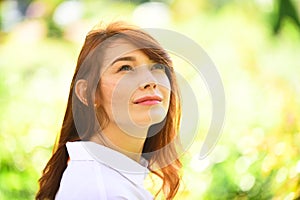 Beautiful woman enjoying daisy field, nice female in meadow. Pretty girl relaxing outdoor, having fun. Happy young lady