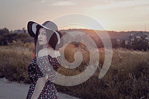 Beautiful woman enjoys nature at sunset