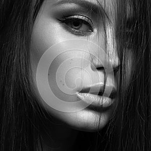 Beautiful woman with evening make-up and long straight hair . Smoky eyes. Fashion photo. Black white photo