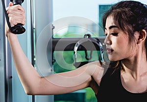 Beautiful woman exercise using machine crossover cable training workout