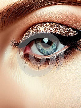 Beautiful woman eye wearing professional glamour makeup