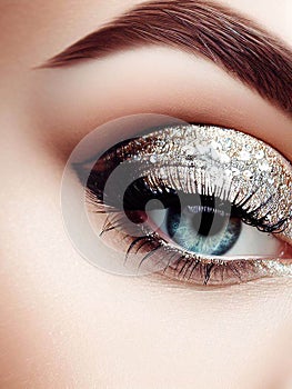 Beautiful woman eye wearing professional glamour makeup