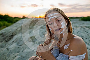 Beautiful Woman With Eyes Closed And White Clay Facial Mask On Face And Body In Nature.