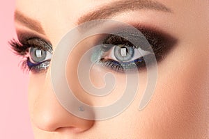 Beautiful woman eyes closeup with black makeup closeup