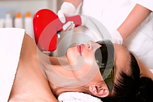 Beautiful woman face on armpits laser hair removal