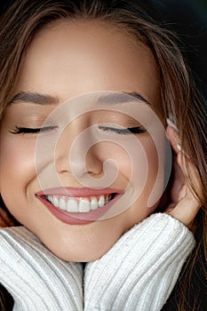 Beautiful woman face close up teeth smile happy positive. Facial treatment, Cosmetology, beauty and spa.