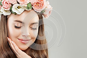 Beautiful Woman Face Closeup. Perfect Young Model Girl with Healthy Skin, Makeup and Flowers. Eyes Closed