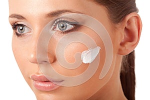 Beautiful woman face with cream