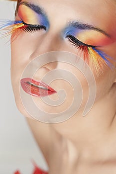 Beautiful woman with face framed in feathers