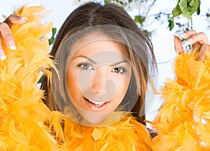 Beautiful woman with face framed in feathers