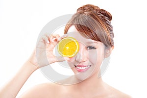 Beautiful woman face with juicy orange