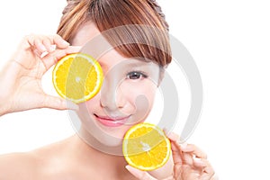 Beautiful woman face with juicy orange