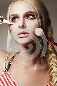 Beautiful woman face. Make-up. apply cosmetics