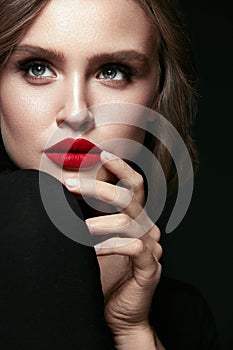 Beautiful Woman Face With Makeup And Red Lips.