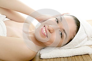 Beautiful woman face massage with white towel