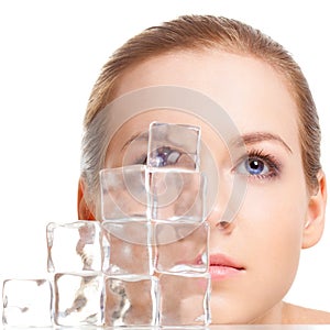 Beautiful woman face near ice cubes