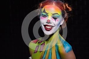 Beautiful woman with a face painting clown