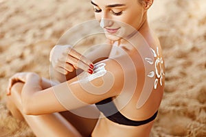 Beautiful Woman Face Portrait Beauty Skin Care Concept. Suncream. Suntan Lotion Beautiful Woman Applying on Shoulder.