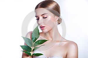 Beautiful woman face portrait with green leaf concept for skin care or organic cosmetics. Studio portrait