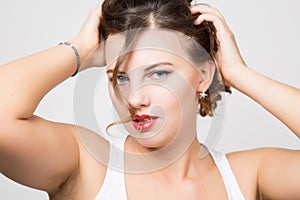 Beautiful woman face portrait with red lips, unruly curl