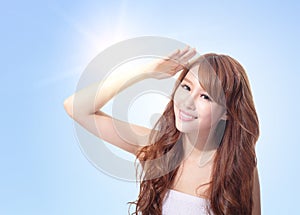 Beautiful woman face with sunshine and sky