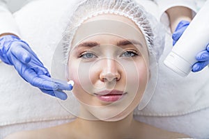 Beautiful woman with facial mask at beauty salon