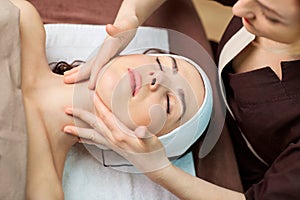 Beautiful woman at a facial massage at a spa salon