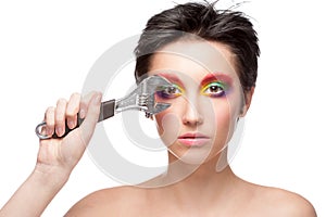 Beautiful woman with fantasy makeup holding wrench