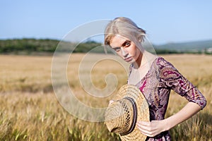Beautiful woman farmer in field of wheat farm