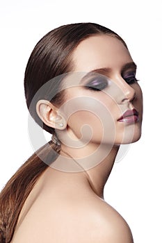 Beautiful Woman with Fashion Makeup. Celebrate Style Smoky Eye Make-up, Shine Skin. Bright Look with Ponytail Hairstyle
