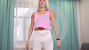 Beautiful woman in fashion sporty clothes making exercize at home. Concept home workouts