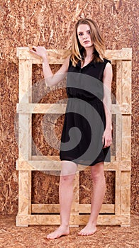 Beautiful woman fashion style posing on wooden wall