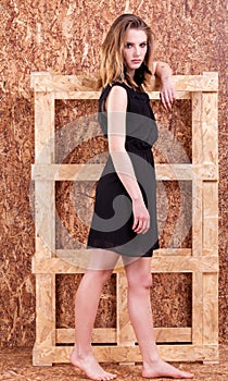 Beautiful woman fashion style posing on wooden wall