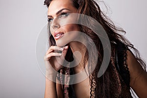 Beautiful woman on fashionable dress pose in studio.