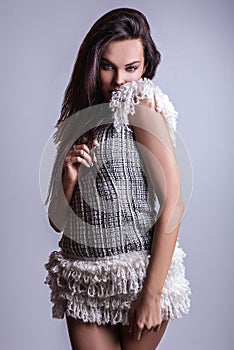 Beautiful woman on fashionable dress pose in studio.