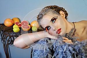 Beautiful woman with feathers and fruit