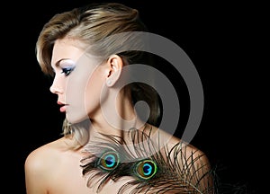 The beautiful woman with feathers of a peacock