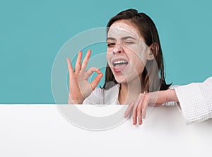 Beautiful woman, female skin care, close up face beauty portrait applying face cream, facial mask cream, isolated