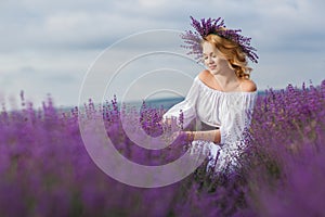 Beautiful woman in a field of blossoming lavender