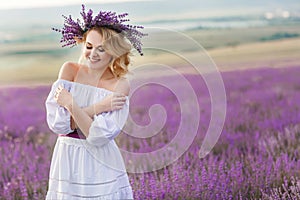 Beautiful woman in a field of blossoming lavender