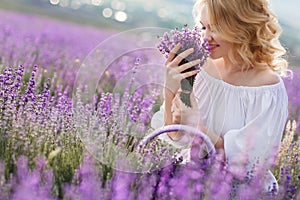 Beautiful woman in a field of blossoming lavender