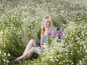 Beautiful woman in the field of camomiles