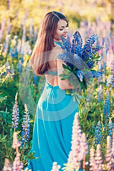 The beautiful woman in field with lupin