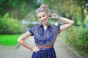 Beautiful woman in fifties style with braces winking